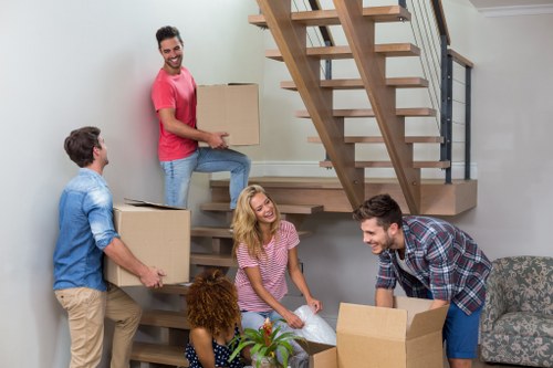 Professional movers preparing a piano removal in Islington