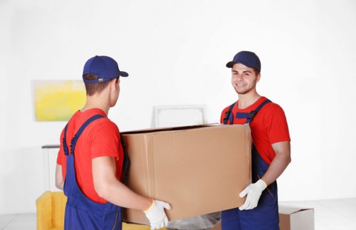Removal team sorting reusable items and recyclables during a move in Islington