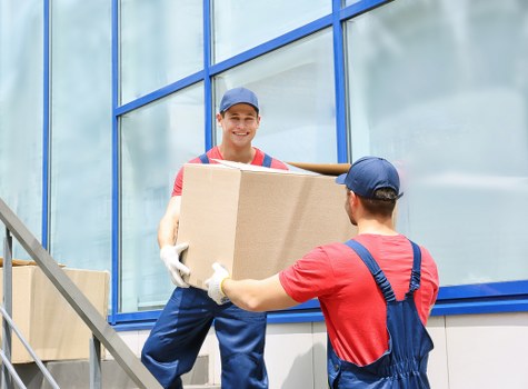 Furniture removals team handling a move in an Islington street