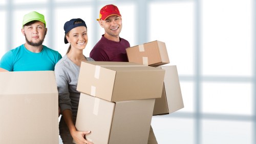 Packed student boxes, study items, and furniture prepared for removals in Islington