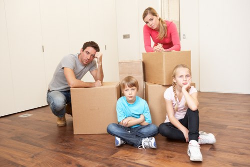 Removal team transporting furniture in Islington