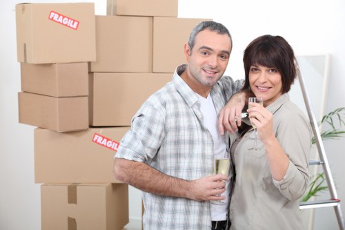 Professional movers navigating a narrow staircase during a flat move in Islington