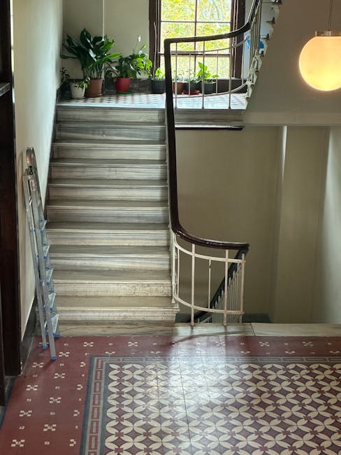 The image shows the front entrance of a residential property, featuring a short concrete staircase with five steps leading up to a black front door numbered '39'. The staircase is flanked by black met